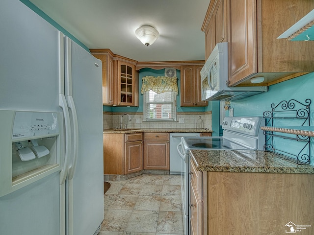 619 Parkwood Ave, Monroe, MI 48162 - kitchen featuring white appliances, a sink, decorative backsplash, brown cabinets, and dark stone countertops