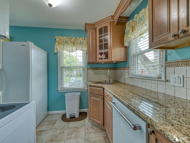 619 Parkwood Ave, Monroe, MI 48162 - kitchen featuring a sink, stainless steel dishwasher, decorative backsplash, brown cabinetry, and glass insert cabinets