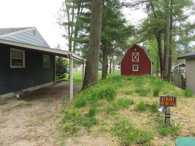 6248 Howard St, Gladwin, MI 48624 - view of yard featuring a barn, an outdoor structure, and a carport