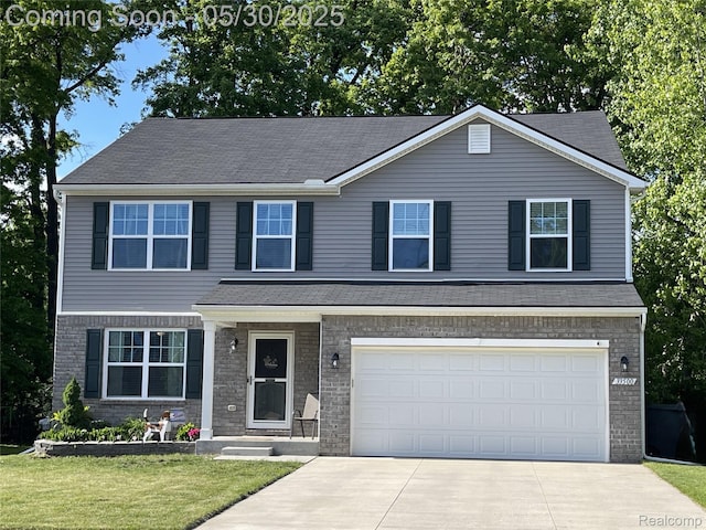33500 Birchlawn, Westland, MI 48185 - view of front of home with driveway, a front yard, an attached garage, and brick siding