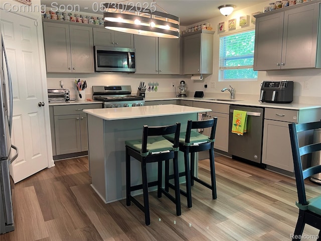 33500 Birchlawn, Westland, MI 48185 - kitchen with stainless steel appliances, a sink, wood finished floors, a center island, and light countertops