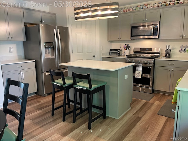 33500 Birchlawn, Westland, MI 48185 - kitchen featuring stainless steel appliances, light wood-style floors, light countertops, a center island, and gray cabinetry