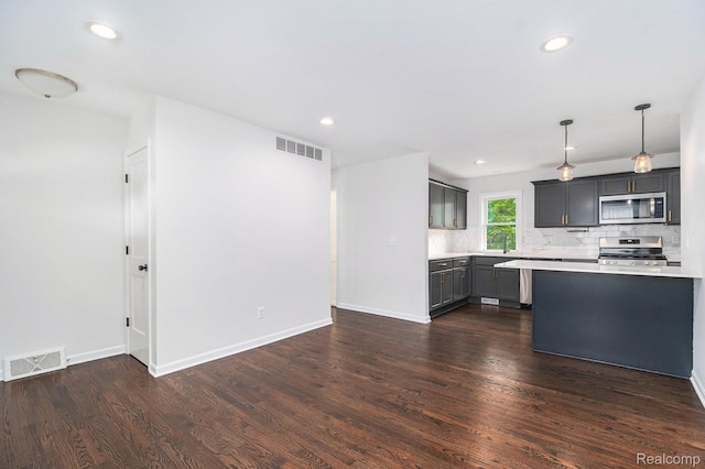 1508 Gardenia Ave, Royal Oak, MI 48067 - kitchen with appliances with stainless steel finishes, light countertops, dark wood-type flooring, decorative backsplash, and baseboards