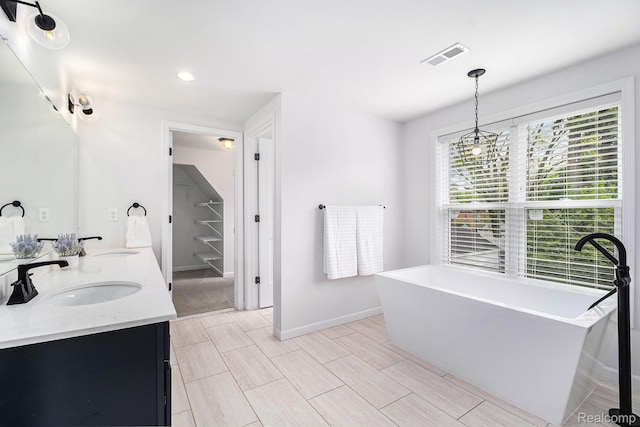 1508 Gardenia Ave, Royal Oak, MI 48067 - bathroom with a freestanding bath, double vanity, baseboards, and recessed lighting
