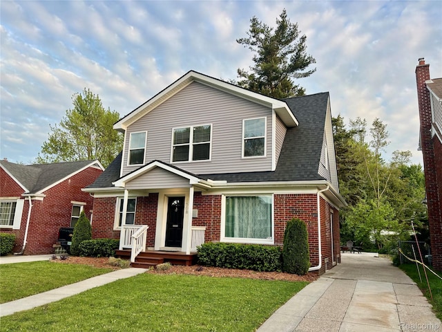 1508 Gardenia Ave, Royal Oak, MI 48067 - traditional home featuring brick siding, a front yard, and a shingled roof