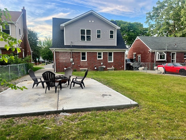 1508 Gardenia Ave, Royal Oak, MI 48067 - rear view of house with a patio area, central air condition unit, a fire pit, and brick siding