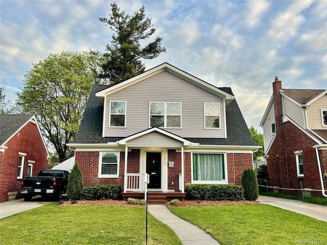 1508 Gardenia Ave, Royal Oak, MI 48067 - view of front of house with brick siding, a front yard, and roof with shingles