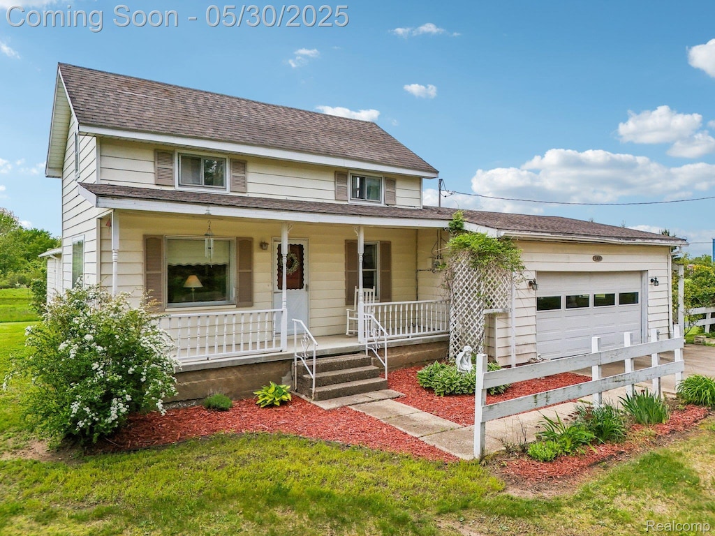 8400 Caine Rd, Millington, MI 48746 - view of front facade with covered porch, an attached garage, driveway, and roof with shingles