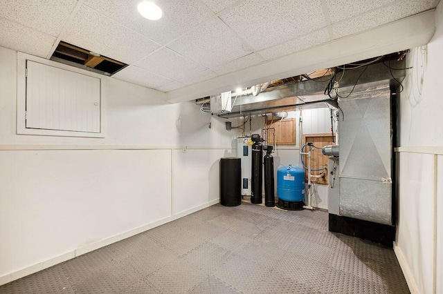 4530 Douglas Ter, Coloma, MI 49038 - basement with a paneled ceiling, a water softener system, a water pressure tank, heating unit, and baseboards