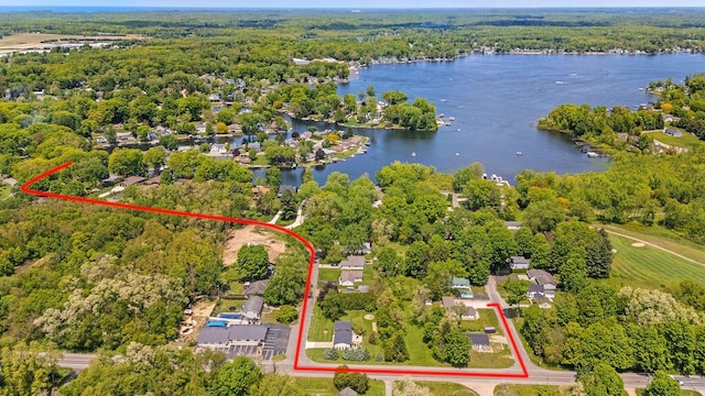 4530 Douglas Ter, Coloma, MI 49038 - aerial view of property and surrounding area with a nearby body of water, property boundaries highlighted, and a heavily wooded area