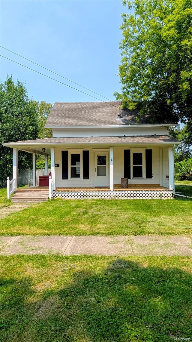 703 Queen St, Owosso, MI 48867 - view of front facade with a porch, a front lawn, and a shingled roof
