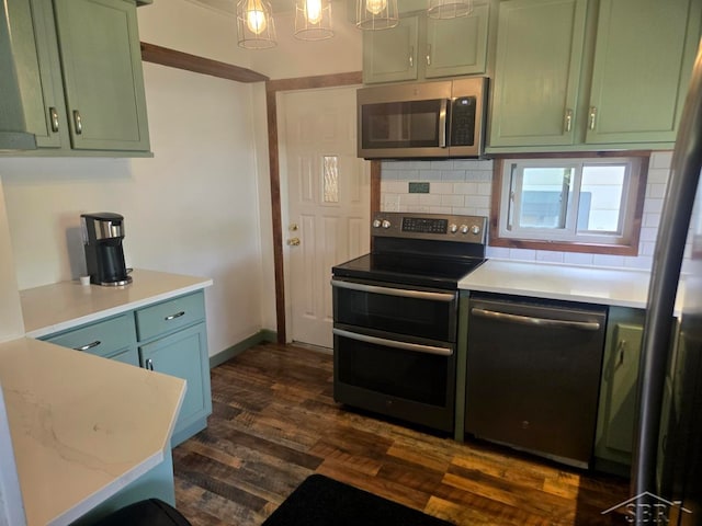 425 Wright St, Breckenridge, MI 48615 - kitchen with appliances with stainless steel finishes, green cabinets, tasteful backsplash, and light countertops