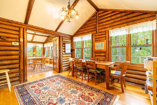 5436 Strawberry Lake Rd, Whitmore Lake, MI 48189 - dining area with rustic walls, light wood-style floors, a chandelier, beam ceiling, and high vaulted ceiling