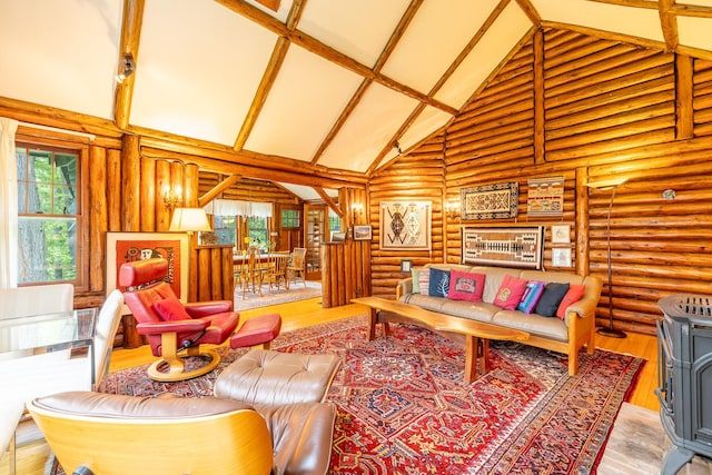 5436 Strawberry Lake Rd, Whitmore Lake, MI 48189 - living room with high vaulted ceiling, log walls, wood finished floors, and a wood stove