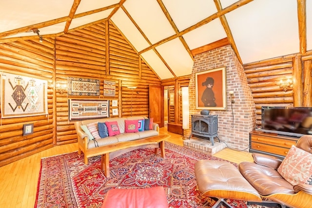 5436 Strawberry Lake Rd, Whitmore Lake, MI 48189 - living area featuring a wood stove, rustic walls, high vaulted ceiling, hardwood / wood-style flooring, and beamed ceiling