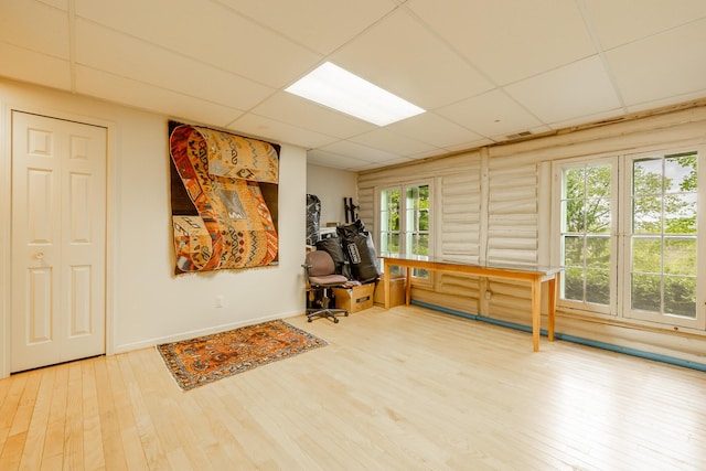 5436 Strawberry Lake Rd, Whitmore Lake, MI 48189 - workout room featuring a drop ceiling, hardwood / wood-style floors, and rustic walls