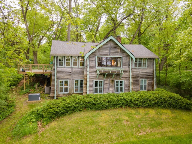 5436 Strawberry Lake Rd, Whitmore Lake, MI 48189 - back of property with a chimney, central air condition unit, a deck, a shingled roof, and a lawn