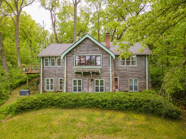 5436 Strawberry Lake Rd, Whitmore Lake, MI 48189 - back of house with a chimney, a shingled roof, a wooden deck, and a lawn