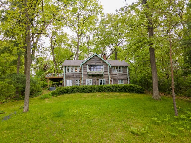 5436 Strawberry Lake Rd, Whitmore Lake, MI 48189 - view of front facade featuring a chimney, a front yard, and a deck