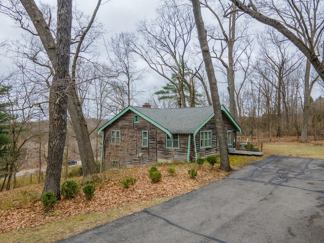 5436 Strawberry Lake Rd, Whitmore Lake, MI 48189 - log cabin featuring a chimney, driveway, roof with shingles, and log siding