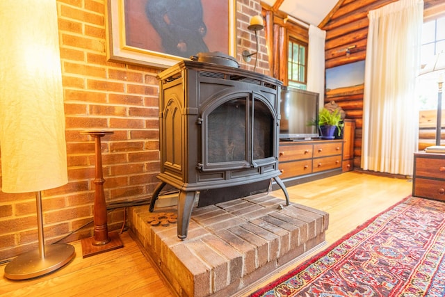 5436 Strawberry Lake Rd, Whitmore Lake, MI 48189 - detailed view of a wood stove, wood finished floors, and log walls