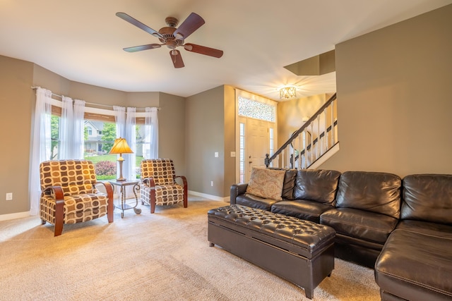 1050 Long Leaf Ct, Brighton, MI 48116 - living room with baseboards, stairs, carpet flooring, and a ceiling fan