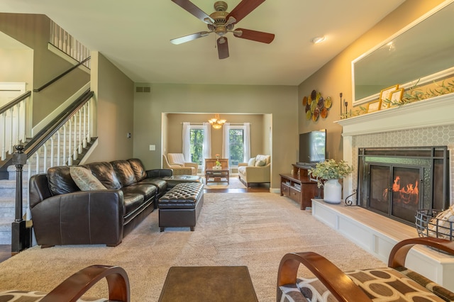 1050 Long Leaf Ct, Brighton, MI 48116 - living area with a ceiling fan, stairway, a fireplace, and carpet flooring