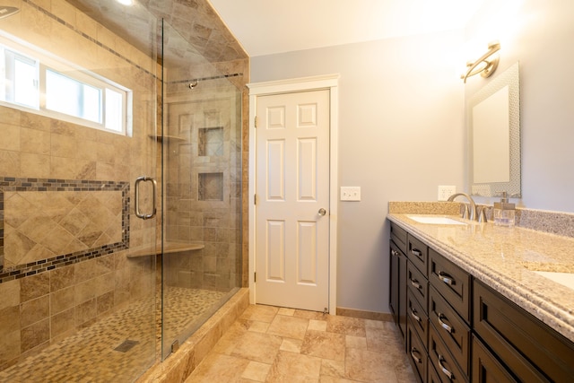 1050 Long Leaf Ct, Brighton, MI 48116 - bathroom featuring a stall shower, double vanity, baseboards, and stone finish floors