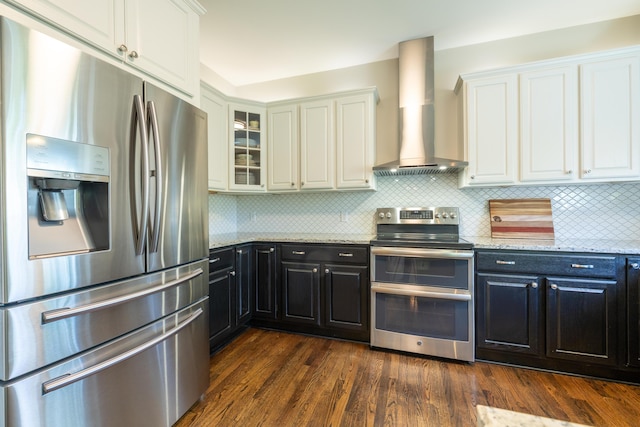 1050 Long Leaf Ct, Brighton, MI 48116 - kitchen with appliances with stainless steel finishes, wall chimney exhaust hood, white cabinets, light stone countertops, and dark cabinets