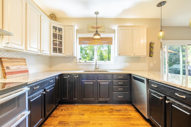 1050 Long Leaf Ct, Brighton, MI 48116 - kitchen featuring stainless steel appliances, white cabinetry, healthy amount of natural light, and light wood-style flooring