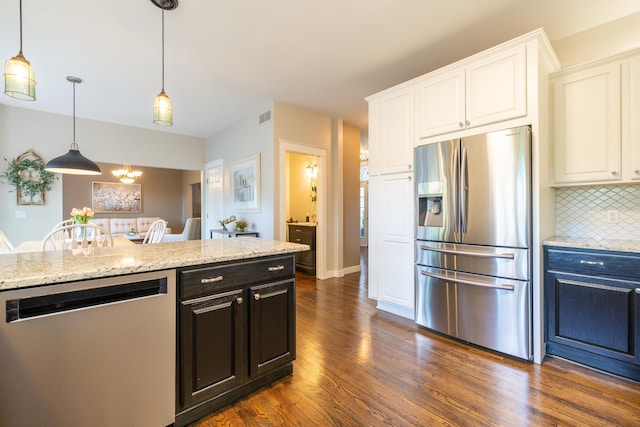 1050 Long Leaf Ct, Brighton, MI 48116 - kitchen with appliances with stainless steel finishes, dark wood finished floors, decorative backsplash, and white cabinetry
