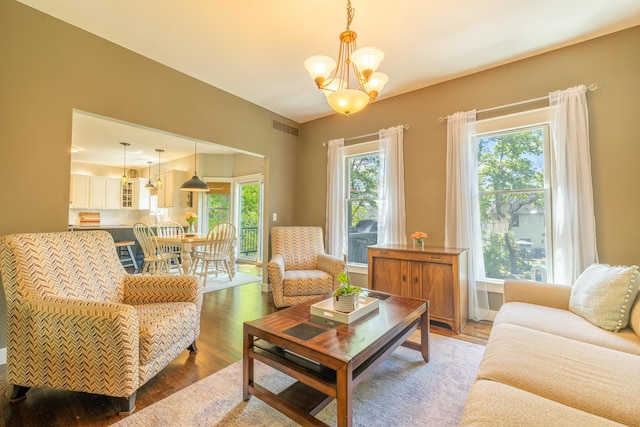 1050 Long Leaf Ct, Brighton, MI 48116 - living area with light wood-style flooring and a chandelier