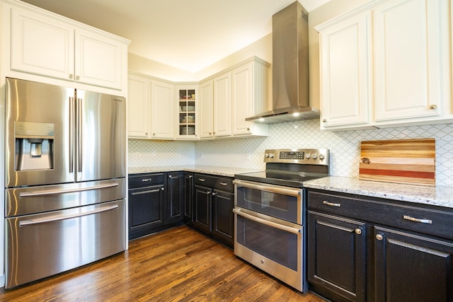 1050 Long Leaf Ct, Brighton, MI 48116 - kitchen with stainless steel appliances, wall chimney range hood, white cabinetry, and dark cabinetry