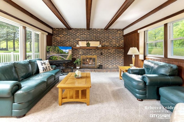 9409 Whitneyville Ave SE, Alto, MI 49302 - carpeted living area with brick wall, healthy amount of natural light, beamed ceiling, and a fireplace
