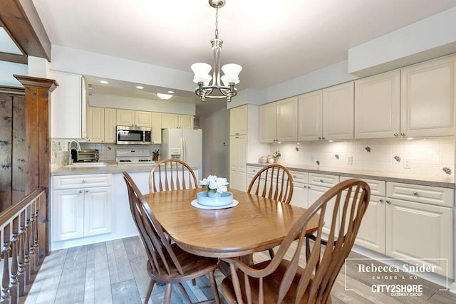 9409 Whitneyville Ave SE, Alto, MI 49302 - dining space with a chandelier, recessed lighting, and light wood finished floors