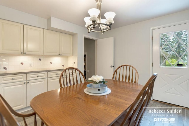 9409 Whitneyville Ave SE, Alto, MI 49302 - tiled dining area featuring a chandelier