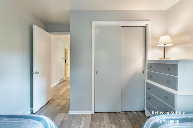9409 Whitneyville Ave SE, Alto, MI 49302 - bedroom featuring wood finished floors and a closet