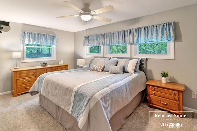 9409 Whitneyville Ave SE, Alto, MI 49302 - bedroom with baseboards, light carpet, and ceiling fan