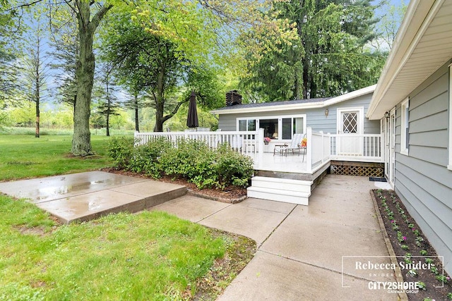9409 Whitneyville Ave SE, Alto, MI 49302 - view of green lawn with a wooden deck and a patio area