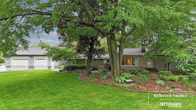 9409 Whitneyville Ave SE, Alto, MI 49302 - view of front facade featuring a front yard, a garage, and a chimney