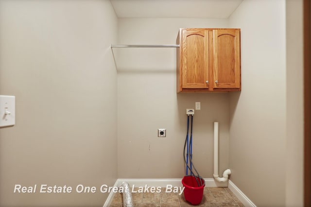 32 Tuscany Cir, Saginaw, MI 48603 - laundry room featuring cabinet space, baseboards, hookup for an electric dryer, and tile patterned flooring
