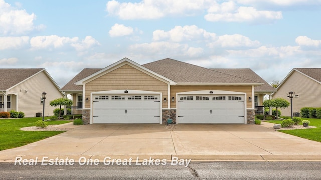 32 Tuscany Cir, Saginaw, MI 48603 - craftsman house featuring an attached garage, stone siding, driveway, and roof with shingles