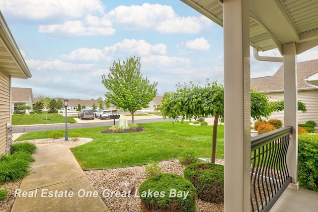 32 Tuscany Cir, Saginaw, MI 48603 - view of green lawn with a residential view and a porch