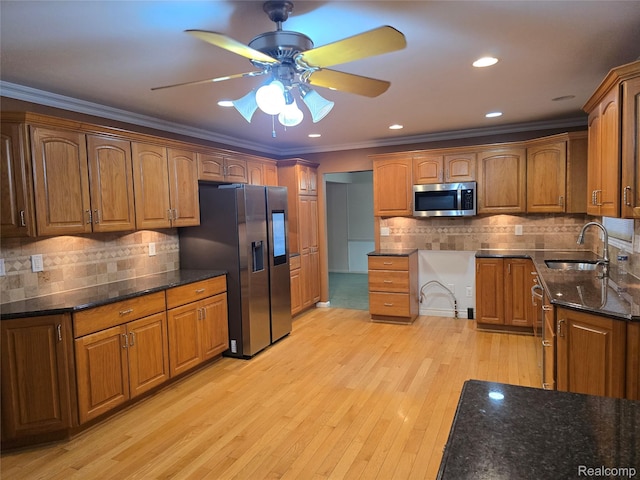 31929 Cambridge Dr, Clinton Township, MI 48093 - kitchen featuring stainless steel appliances, a sink, crown molding, ceiling fan, and dark stone countertops