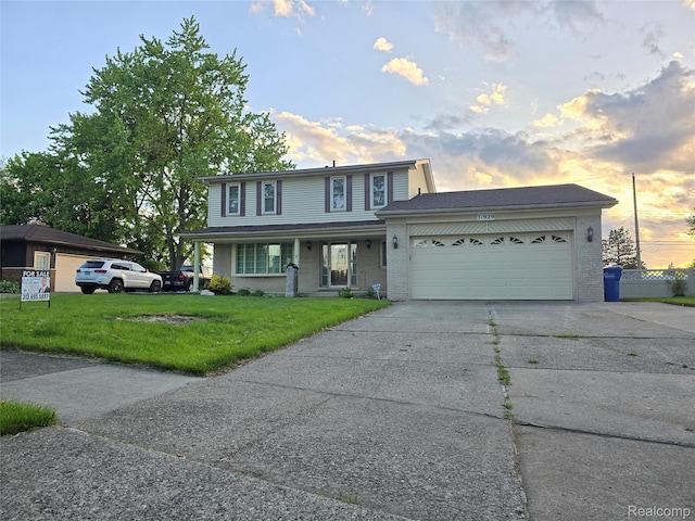 31929 Cambridge Dr, Clinton Township, MI 48093 - view of front facade featuring a front yard, an attached garage, driveway, brick siding, and a porch