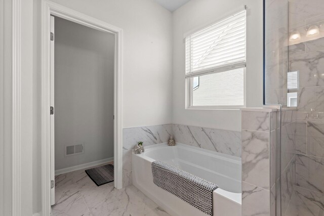 2771 Silo Dr, Saline, MI 48176 - bathroom with a garden tub, marble look tile flooring, and a marble finish shower