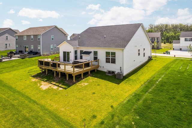2771 Silo Dr, Saline, MI 48176 - rear view of house with a deck, a lawn, an outdoor fire pit, and central air condition unit