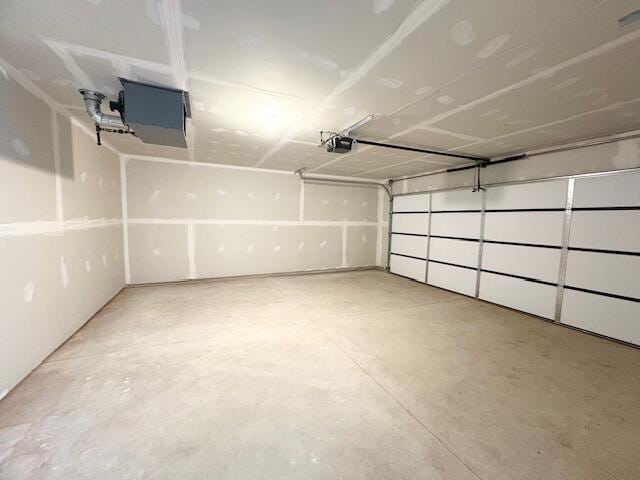 8121 Bowens Mill Rd, Middleville, MI 49333 - garage featuring a garage door opener