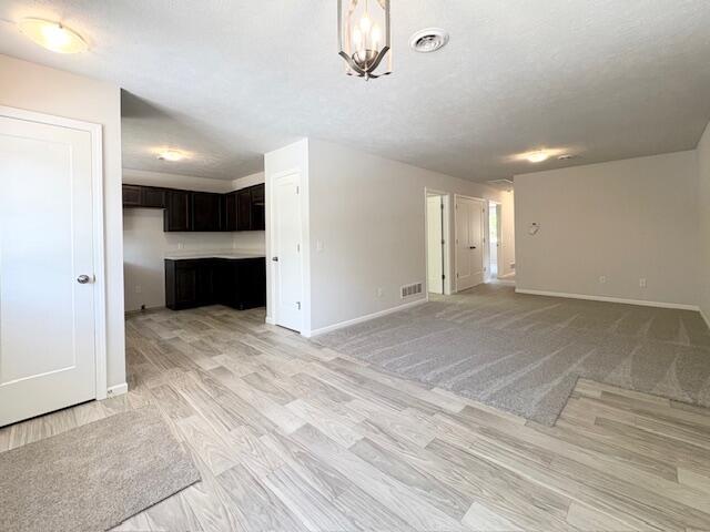 8121 Bowens Mill Rd, Middleville, MI 49333 - unfurnished living room featuring baseboards and light wood-type flooring