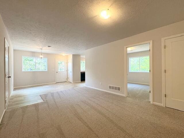 8121 Bowens Mill Rd, Middleville, MI 49333 - unfurnished room featuring a textured ceiling, light colored carpet, and baseboards